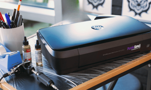 Tattoo shop - M250 on desk with logo