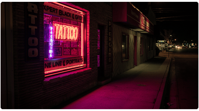 Tattoo shop store front with neon light